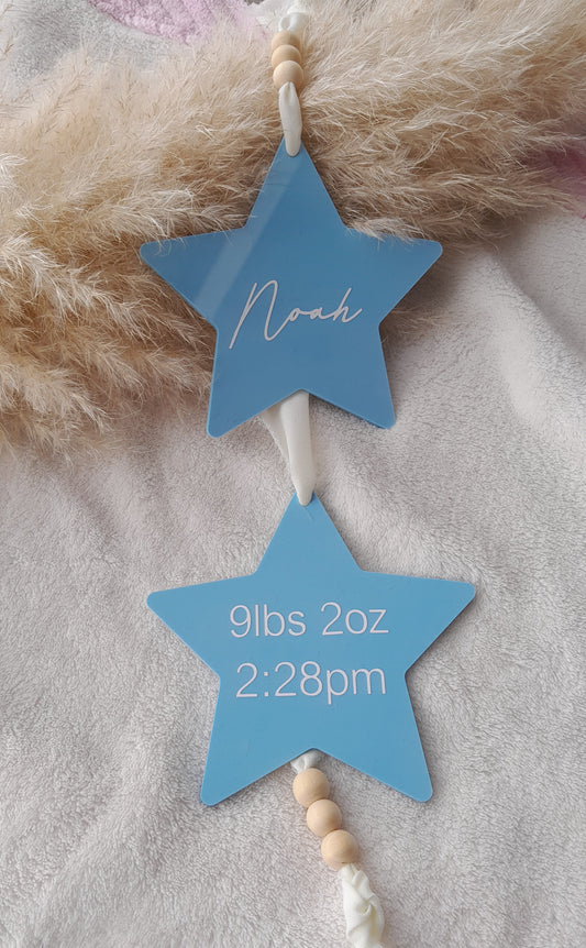 Acrylic Hanging star baby sign for nursery. 2 stars hung on white ribbon with wooden beads. Displays babies name, weight and time.